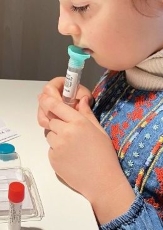 Image showing a child patient taking the RT-PCR test.