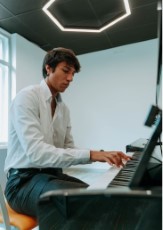 Image showing a student playing piano in the new Daniel Casas building.