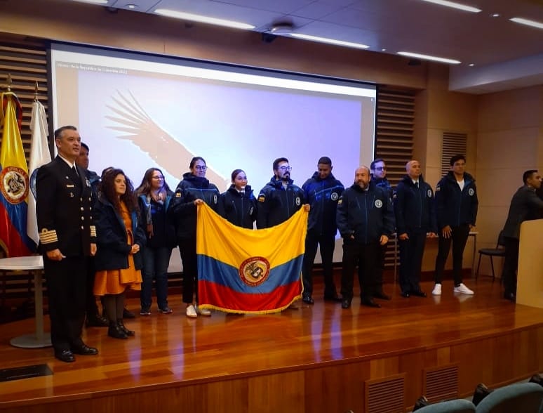 Imagen que muestra la entrega de la bandera del país a los científicos colombianos.
