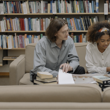 The School of Physics UIS presents to the educational community and the general public the research lines of its Optics and Signal Processing Group(GOTS). Photo taken from stock images showing two students in a library.